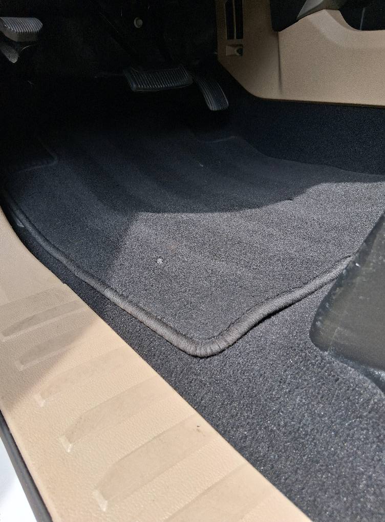 Restored black car carpet after deep cleaning