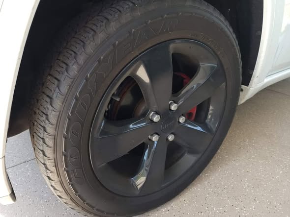 Dirty vehicle wheel before professional detailing