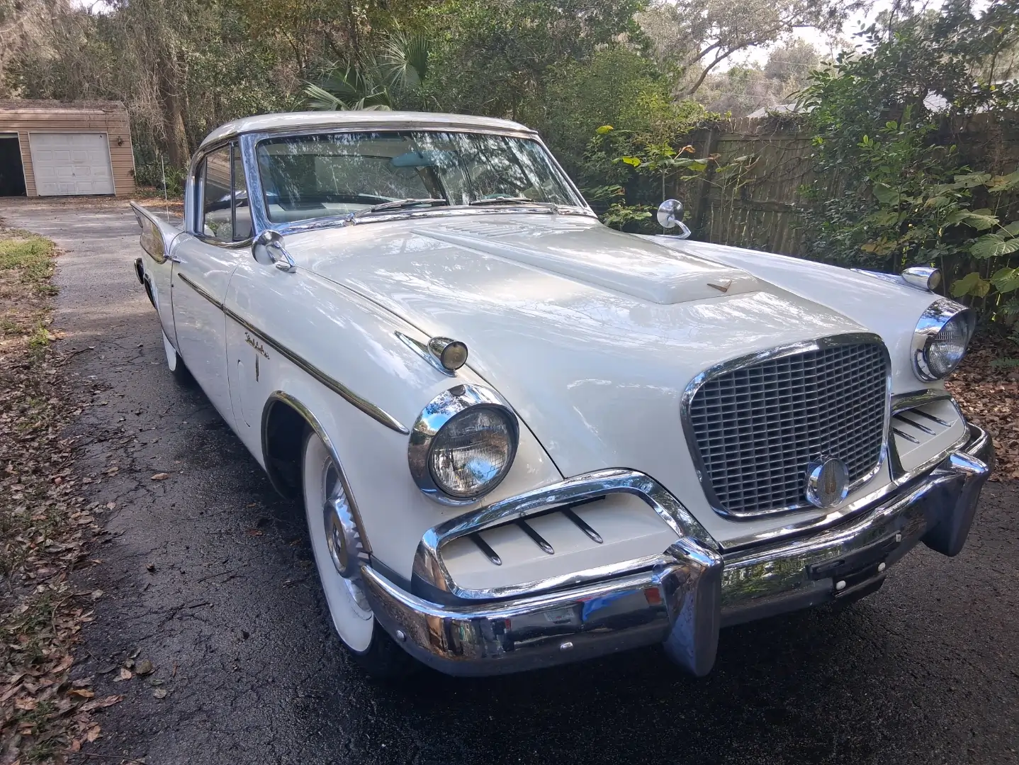 Classic white Studebaker Hawk detailed exterior with chrome polish and paint restoration