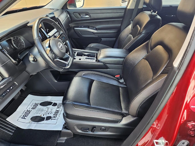 Professional automotive interior detailing showing clean black leather seats and dashboard at Diamond Auto Spa